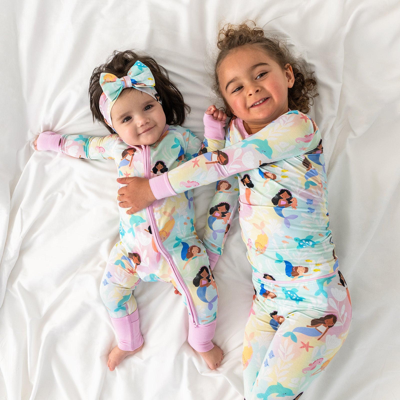 Two children wearing matching Mystic Mermaids bamboo kids pajamas