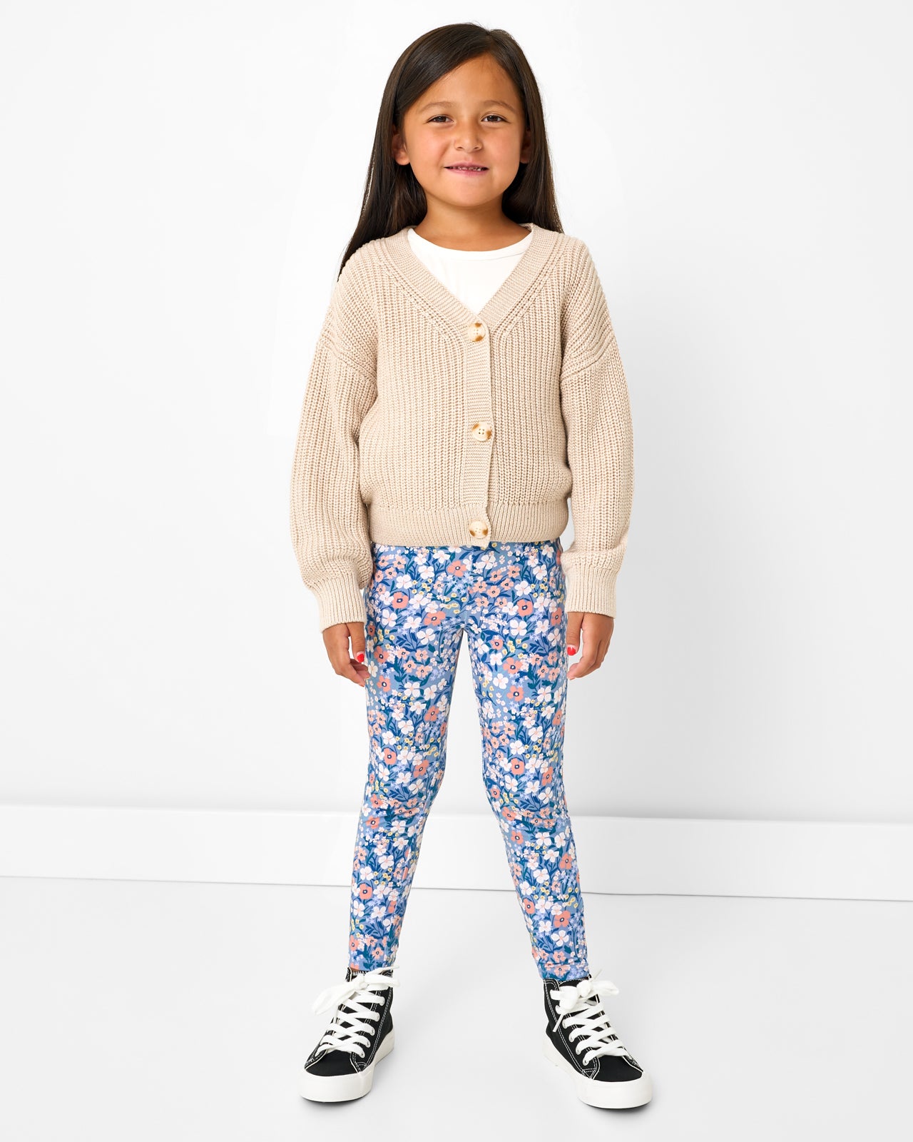 Girl wearing the Natural Heather Cropped Sweater with floral leggings