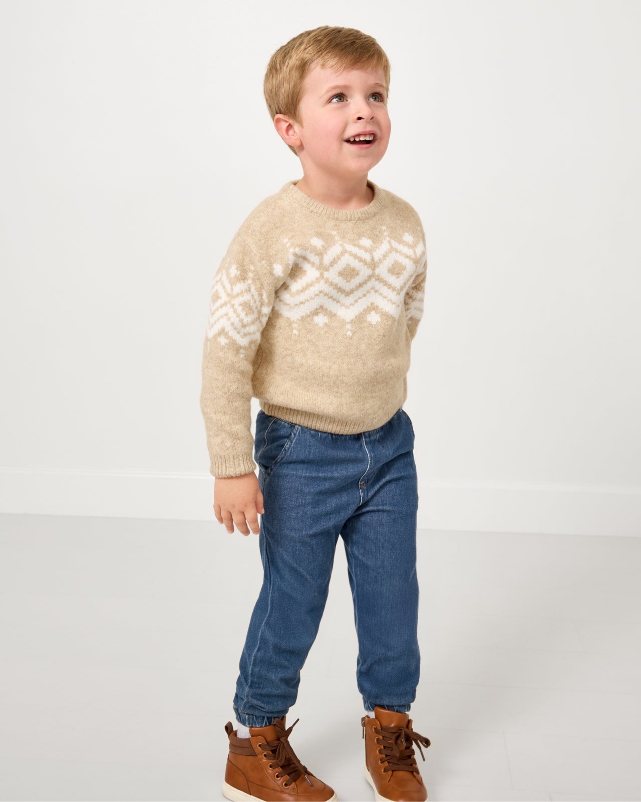 Boy wearing the Neutral Fair Isle Sweater with denim joggers