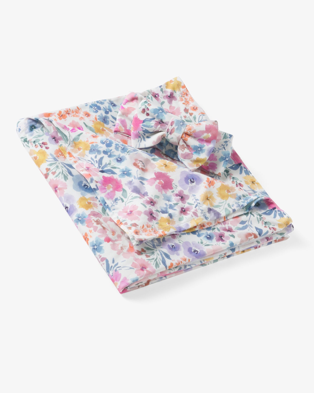 Flat lay of the Tiny Blooms Swaddle & Luxe Bow Headband Set
