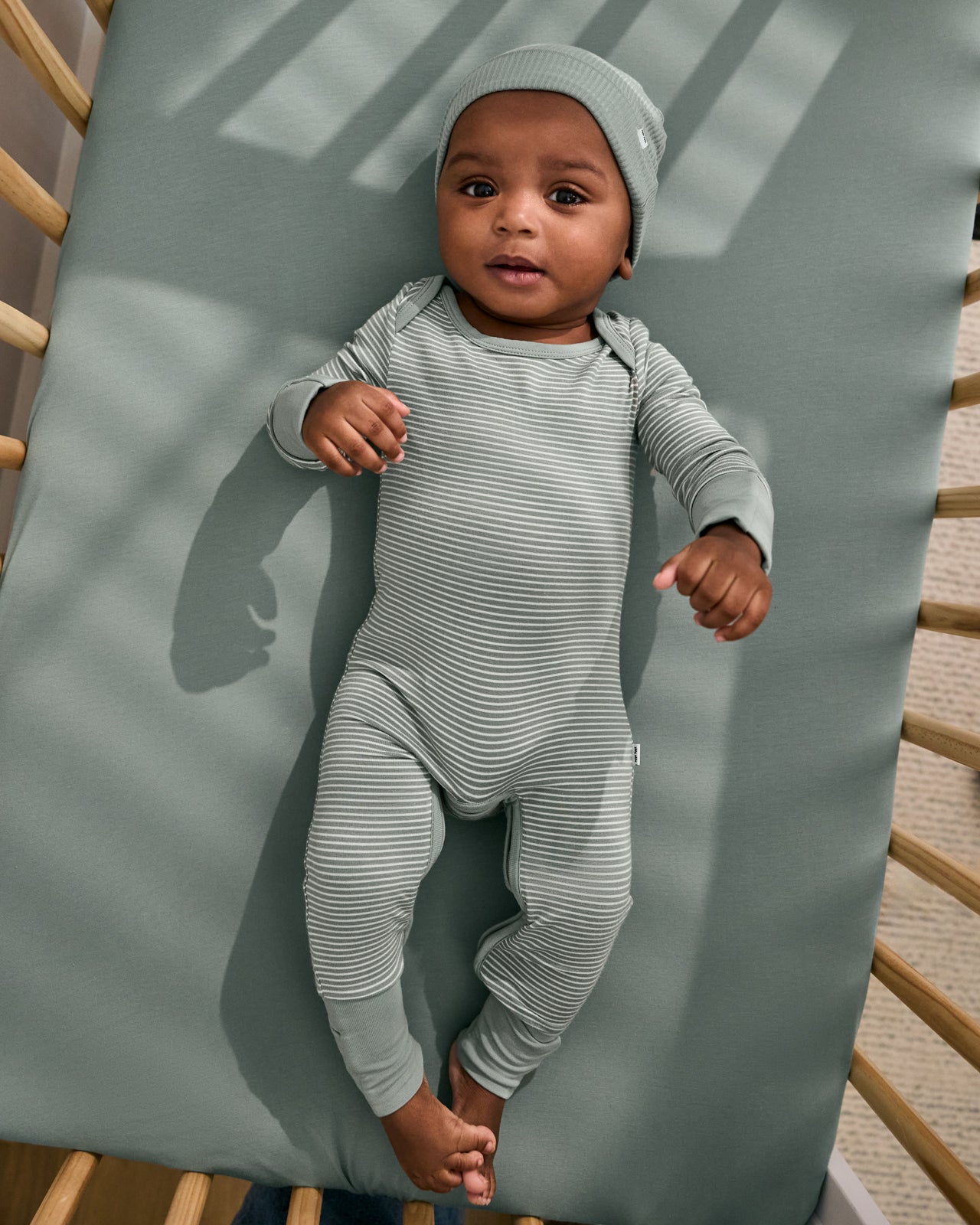 Aerial view of baby wearing the Willow Stripe Crescent Zippy