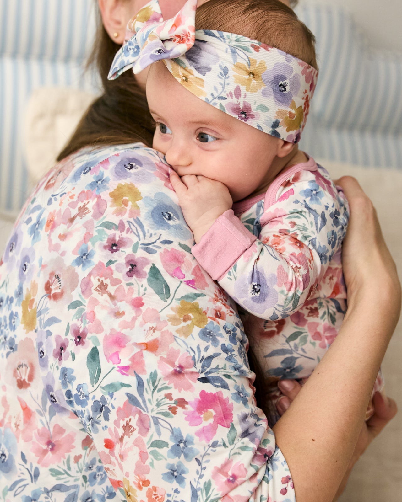 Mother holding baby wearing the Tiny Blooms Luxe Bow Headband