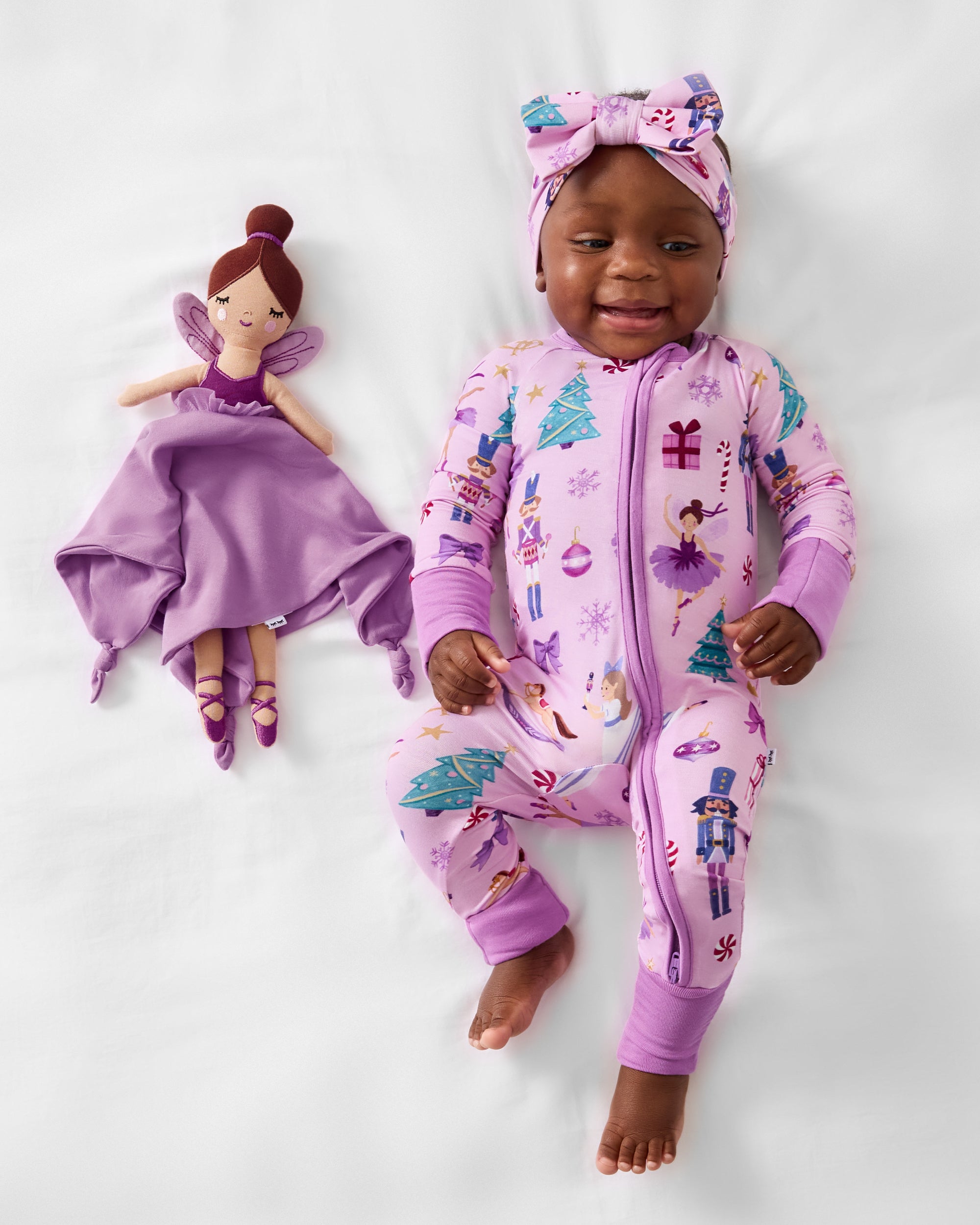 Baby laying with the Marie the Sugarplum Fairy Sleepyhead Lovey