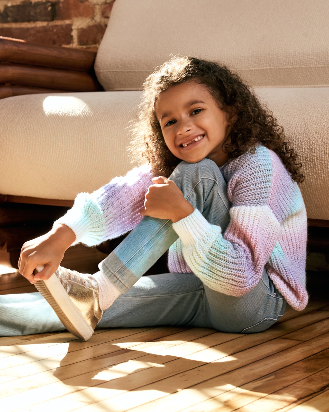 Sitting girl wearing the Frosty Ombre Drop Shoulder Sweater