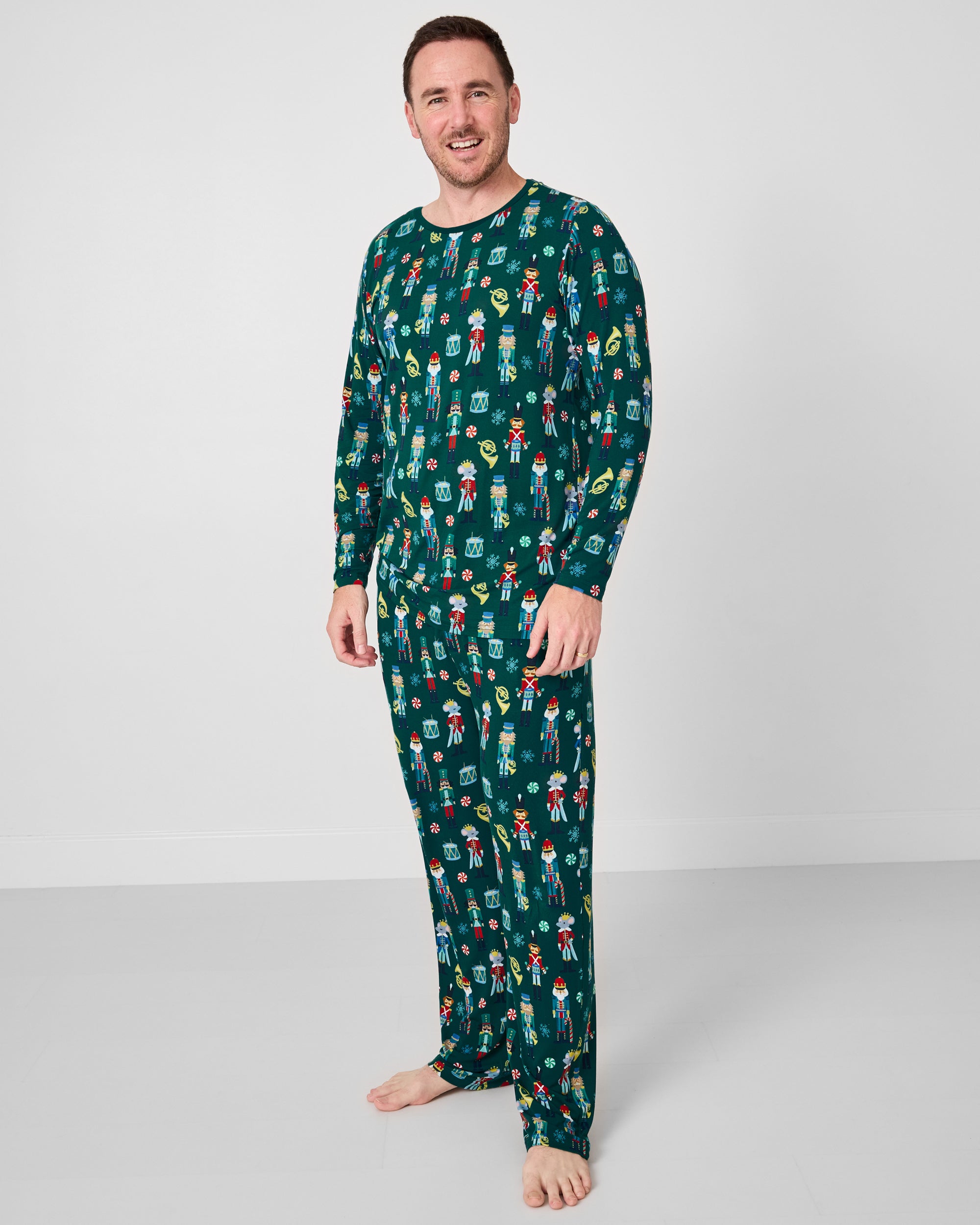 Man wearing the Nutcracker March Men's Pajama Pants with the coordinating top