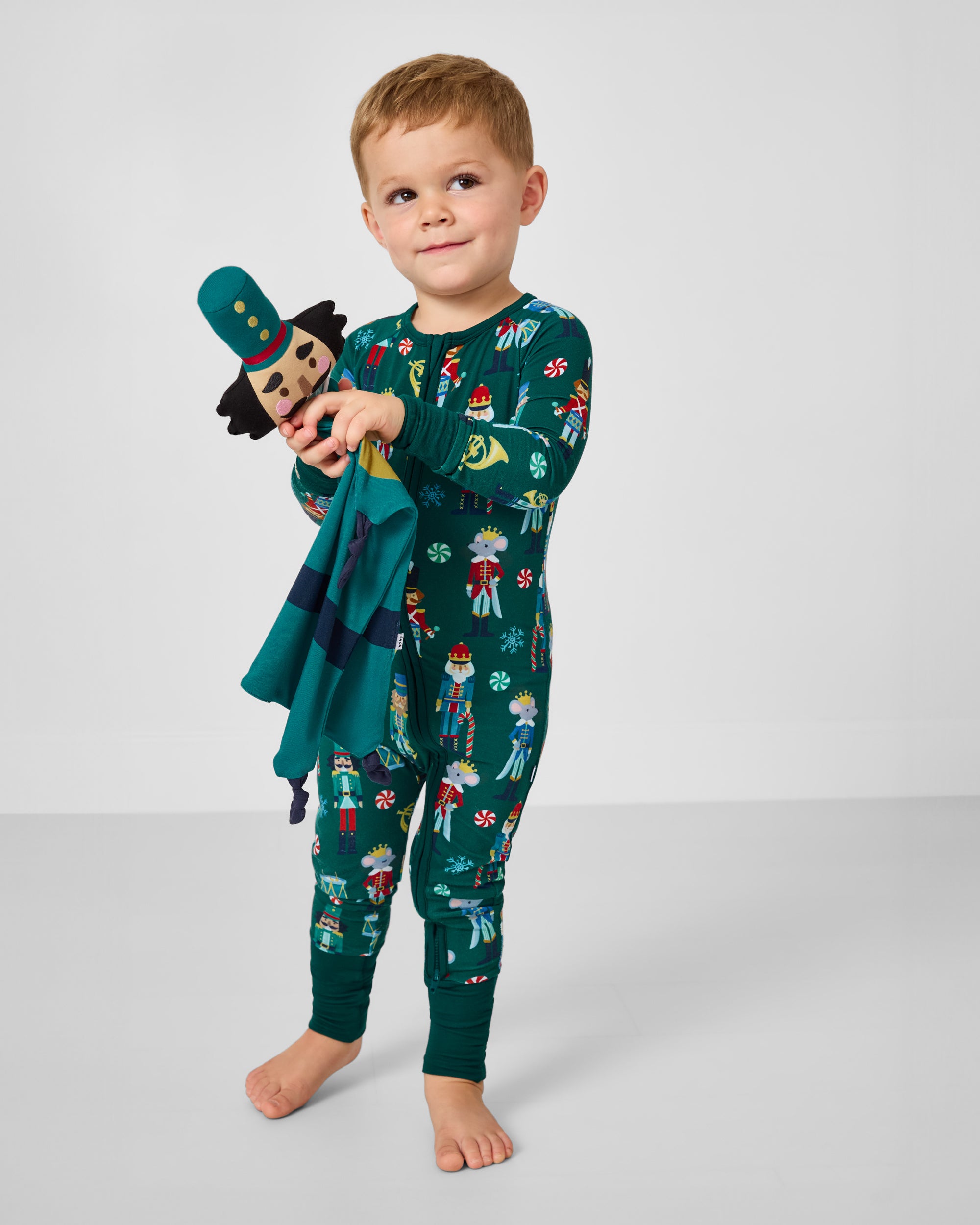 Boy holding the Hans the Nutcracker Sleepyhead Lovey