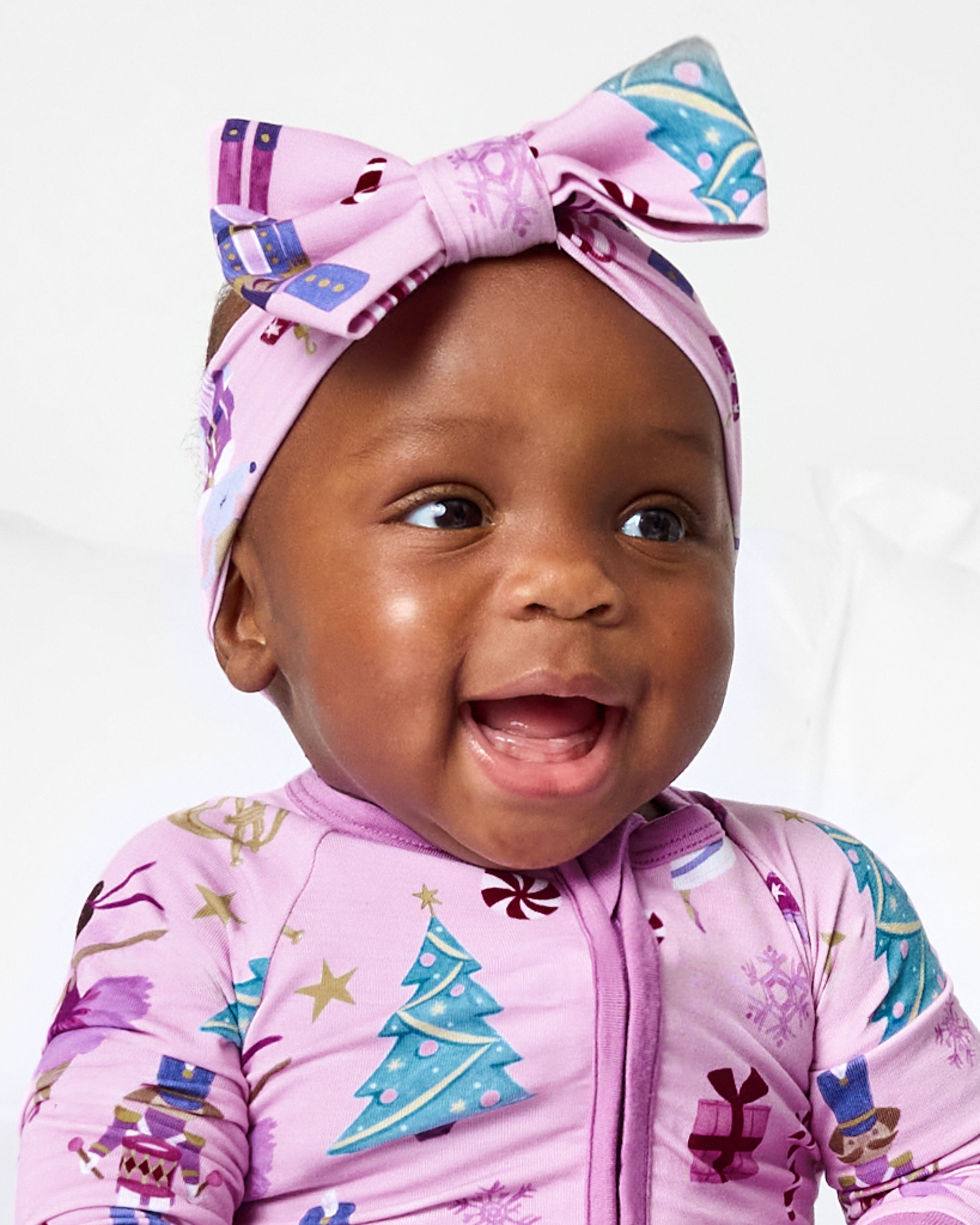 Close up of baby wearing the Nutcracker Ballet Luxe Bow Headband