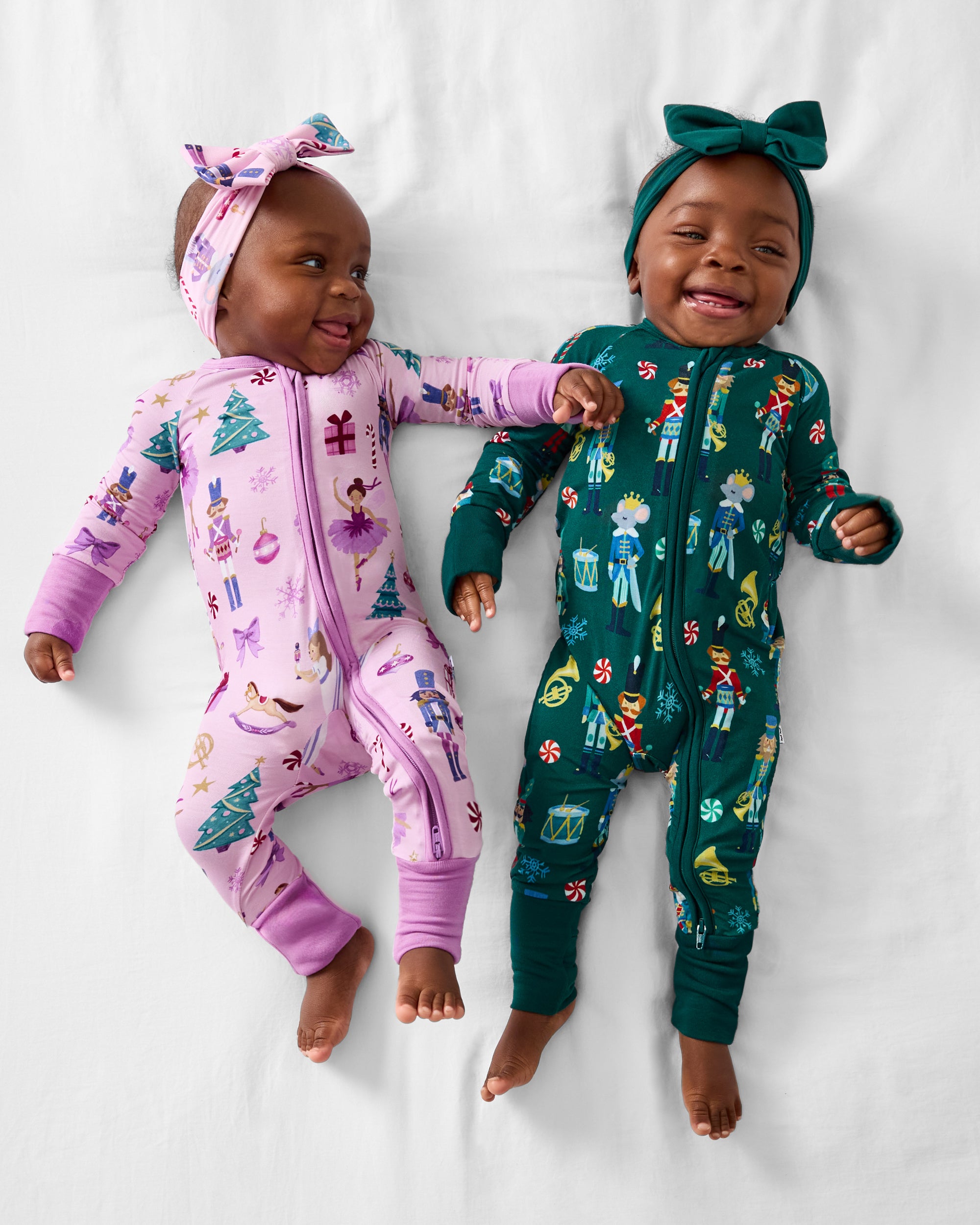 Aerial view of two babies wearing Nutcracker March and Nutcracker ballet Zippys