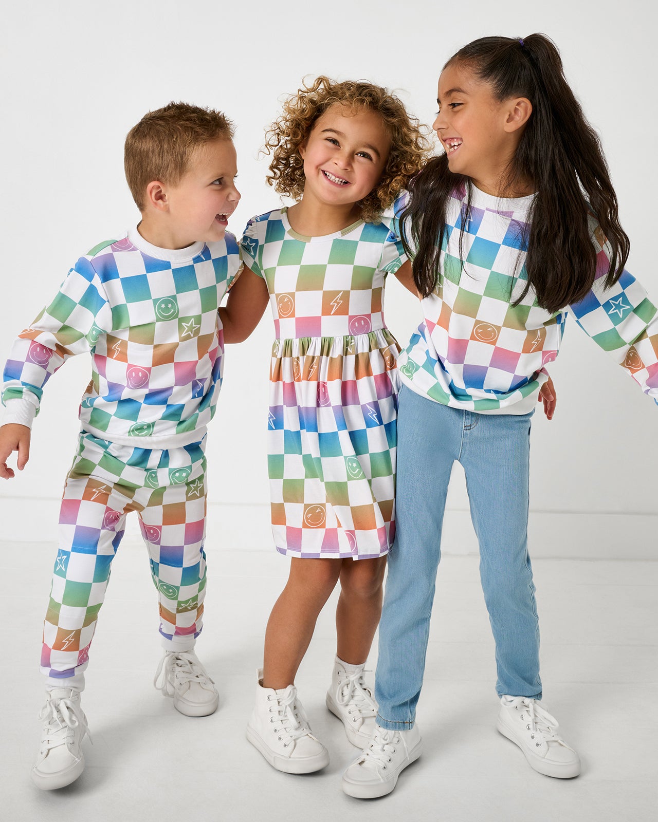 Group of three children wearing Ombre Cheery Checks play styles