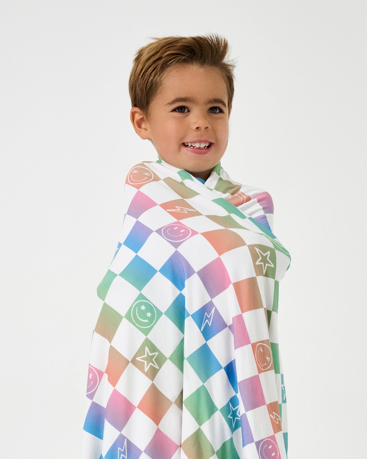 Boy wrapped in the Ombre Cheery Checks Large Cloud Blanket®