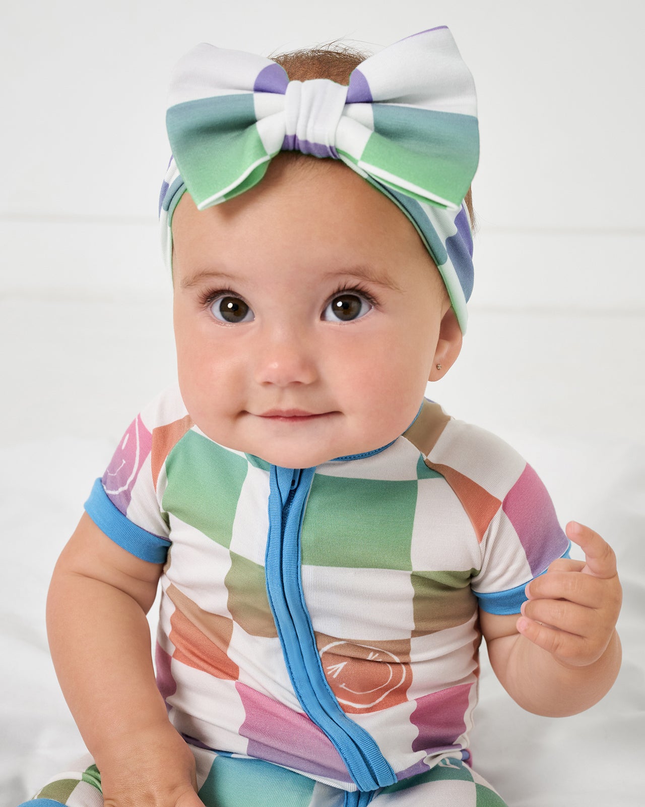 Baby wearing the Ombre Cheery Checks Luxe Bow Headband