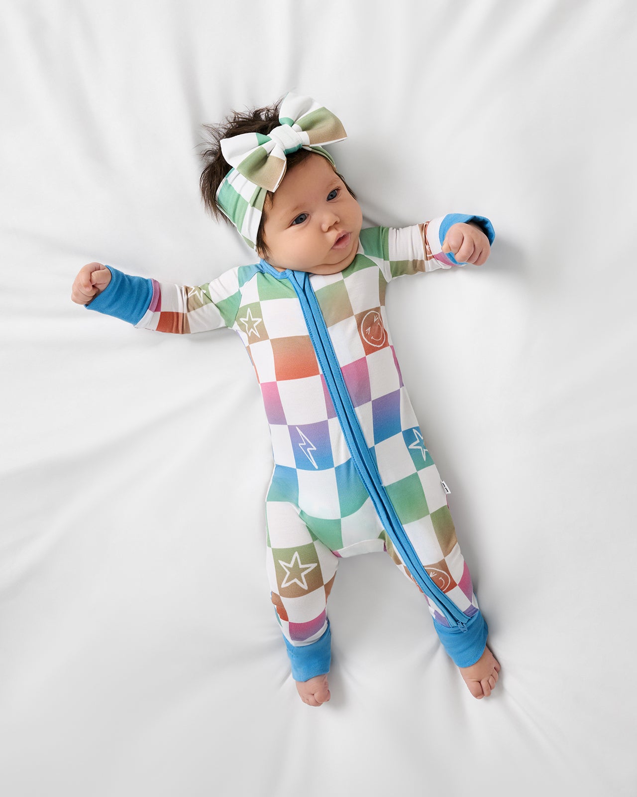 Aerial view of baby wearing the Ombre Cheery Checks Zippy and Luxe Bow Headband