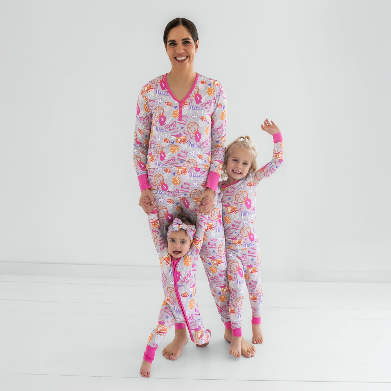 Mother and two children wearing matching Pink Slam Dunk bamboo pajamas