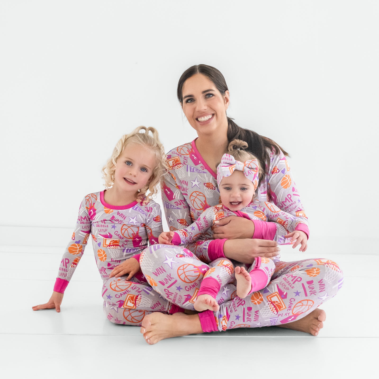 Mother and two children wearing matching Pink Slam Dunk pajamas
