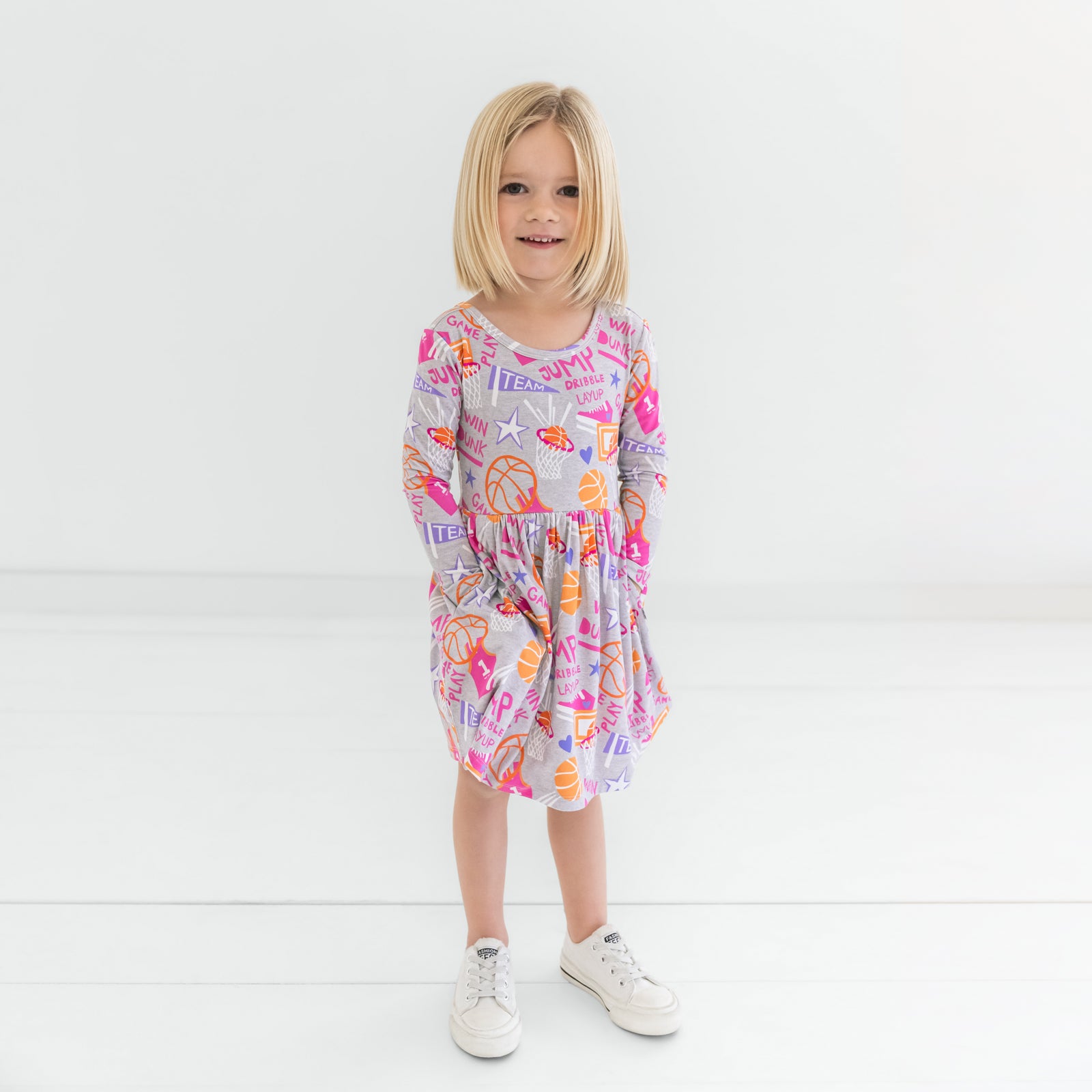 Child standing wearing the Pink Slam Dunk Skater Dress