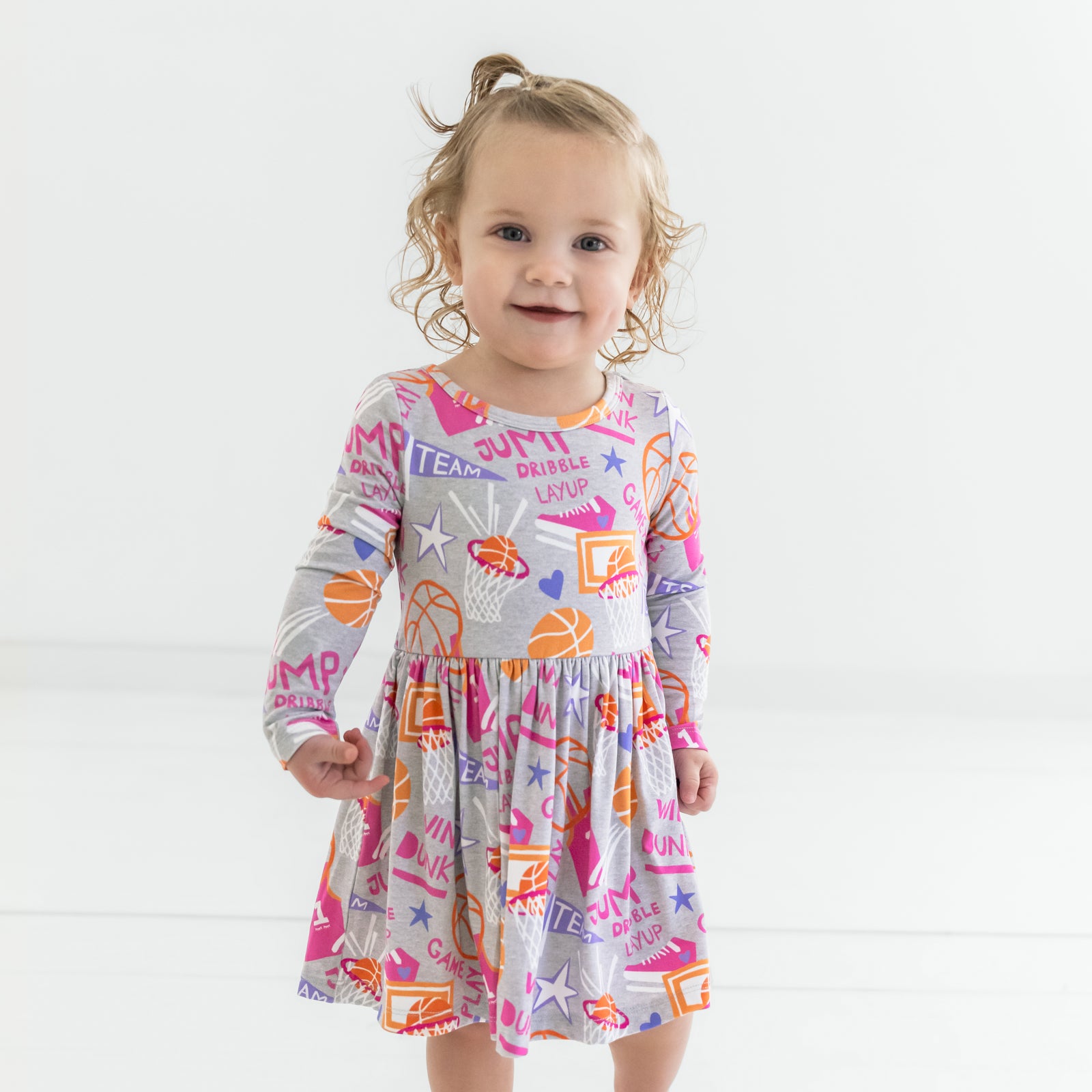 Close up of a child wearing the Pink Slam Dunk Skater Dress with Bodysuit