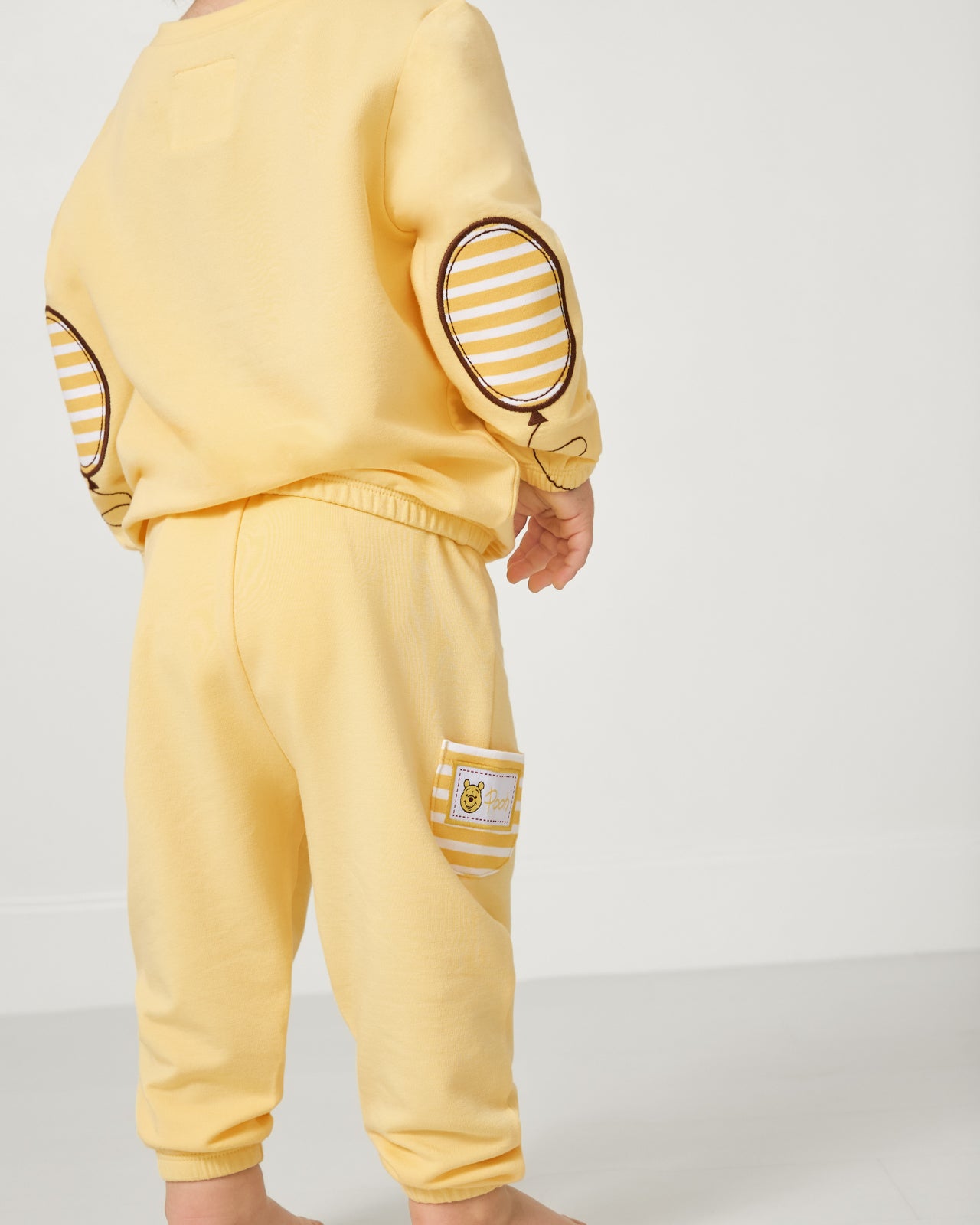 Close up of the Winnie the Pooh details on the Disney Winnie The Pooh Cinched Jogger and Crewneck