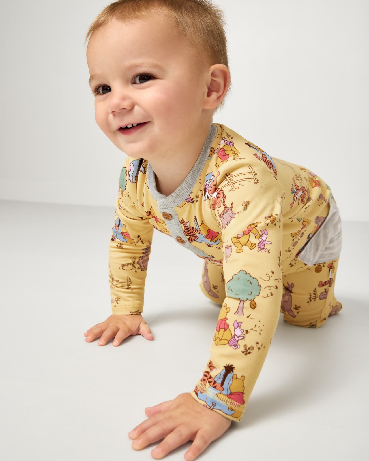 Crawling child wearing the Disney Playtime With Pooh Henley Romper