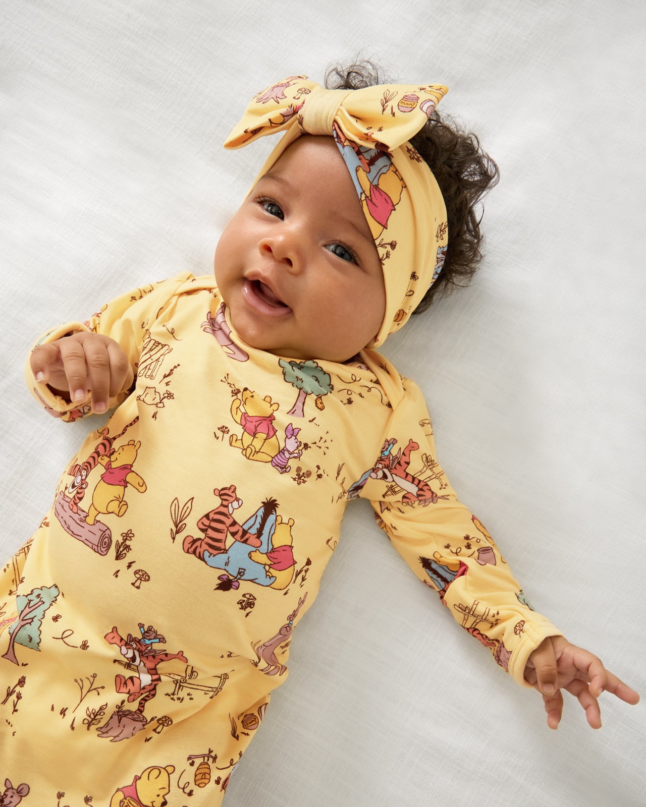 Close up of baby wearing the Disney Playtime With Pooh Infant Gown