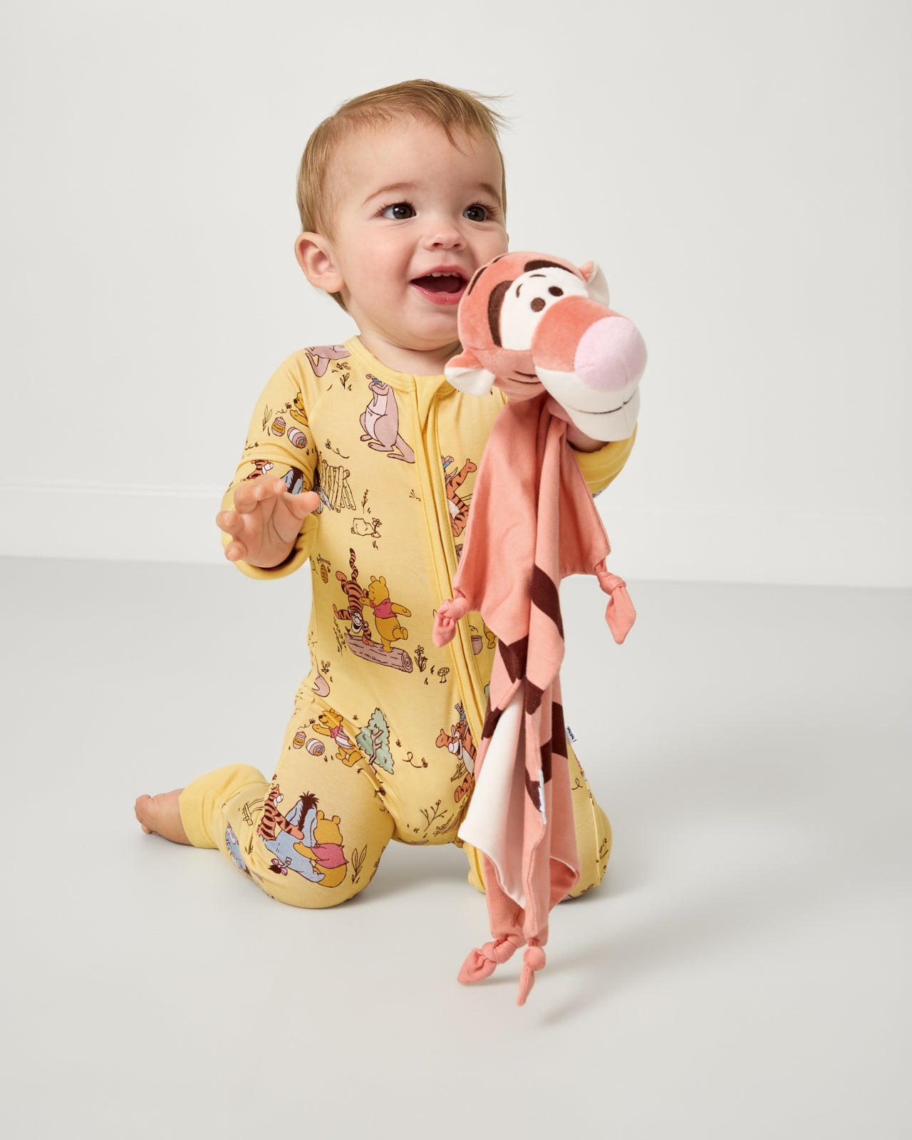 Baby holding the Disney Tigger Lovey