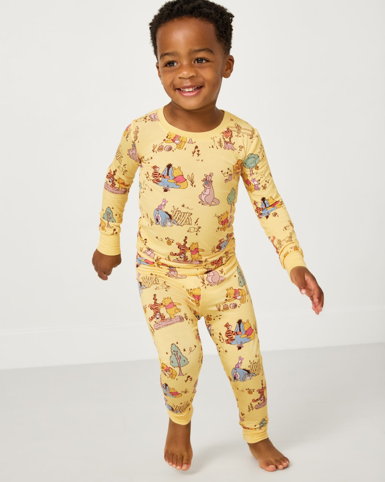 Boy wearing the Disney Playtime With Pooh Two-Piece Pajama Set