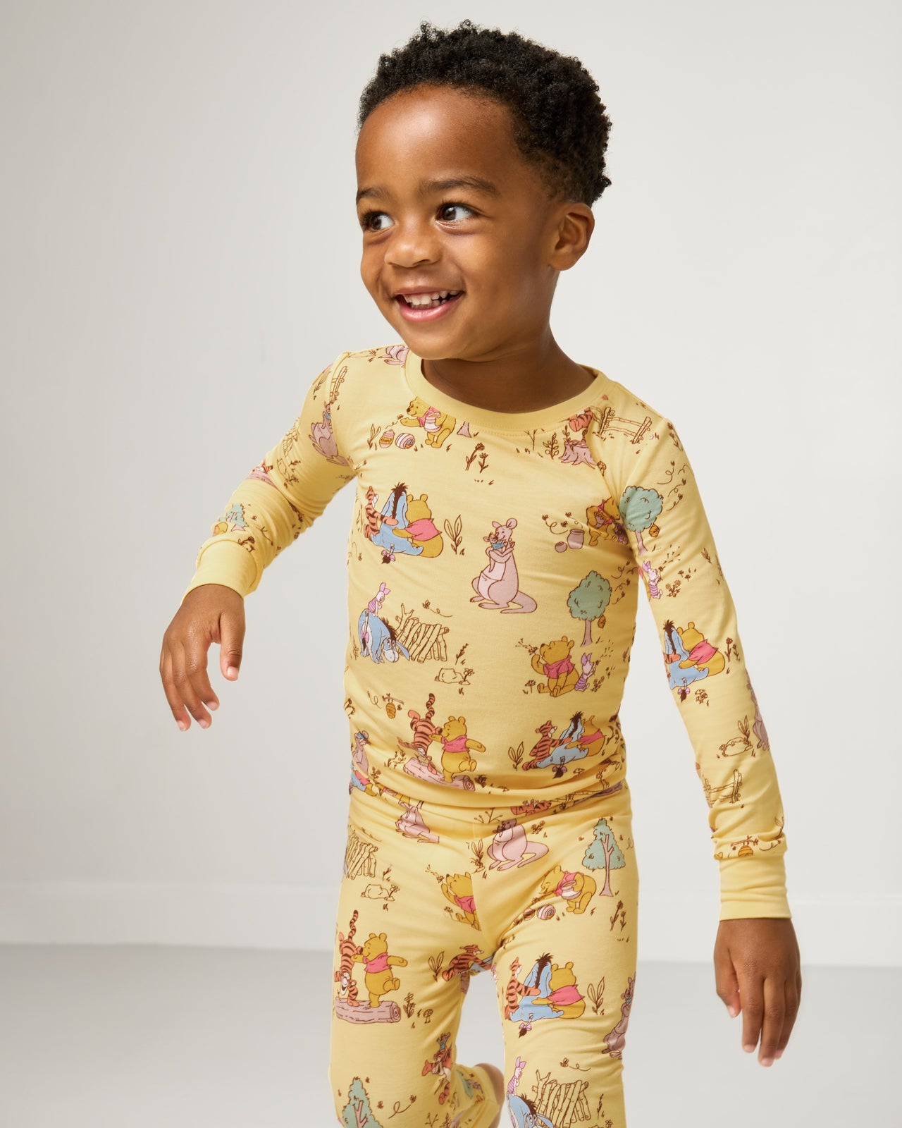 Close up of boy wearing the Disney Playtime With Pooh Two-Piece Pajama Set