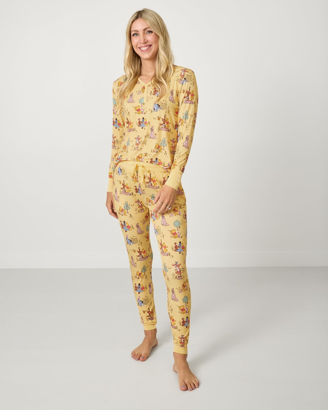 Woman wearing the Disney Playtime With Pooh Women's Pajama Pants and matching top