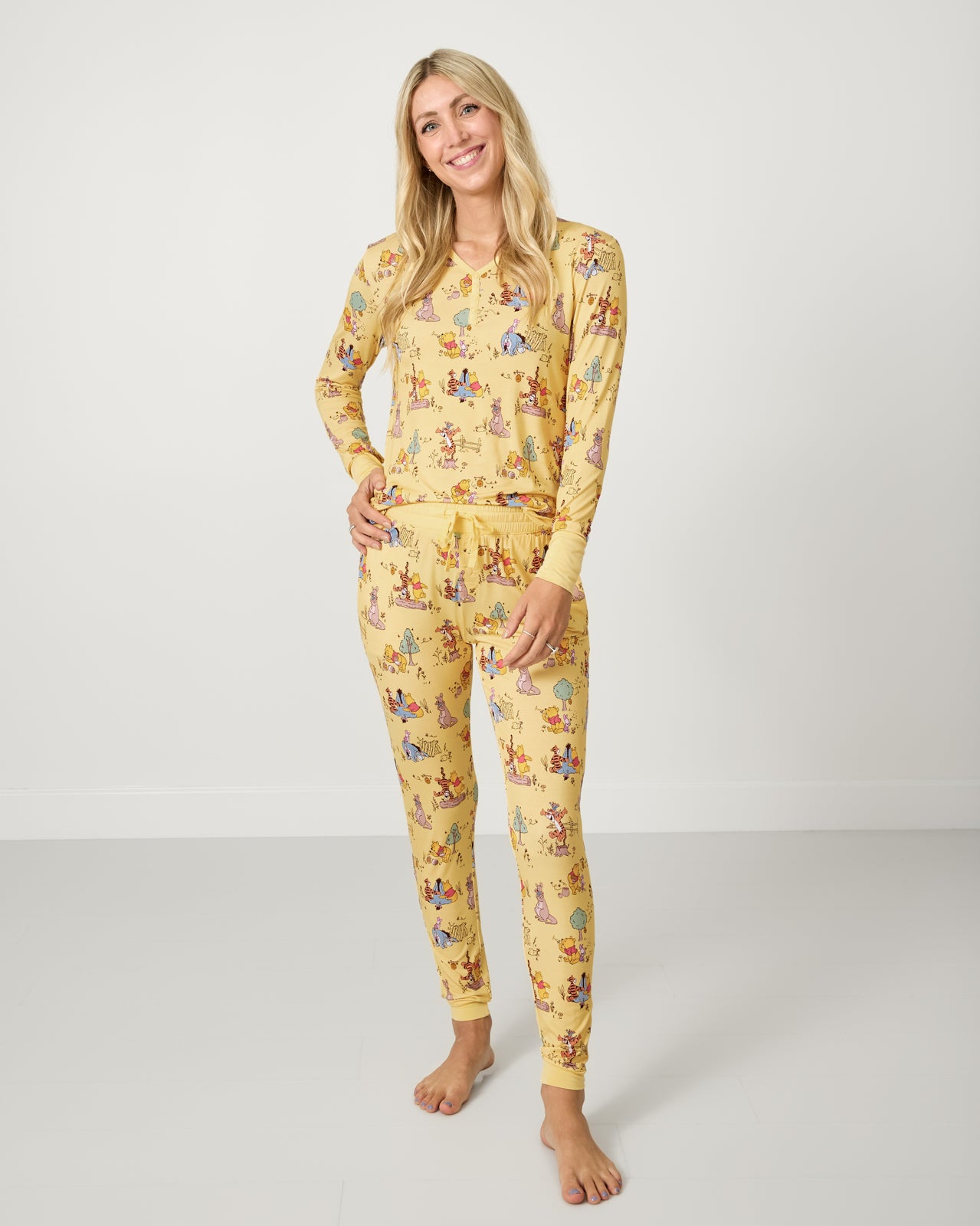 Woman wearing the Disney Playtime With Pooh Women's Pajama Top and Pants