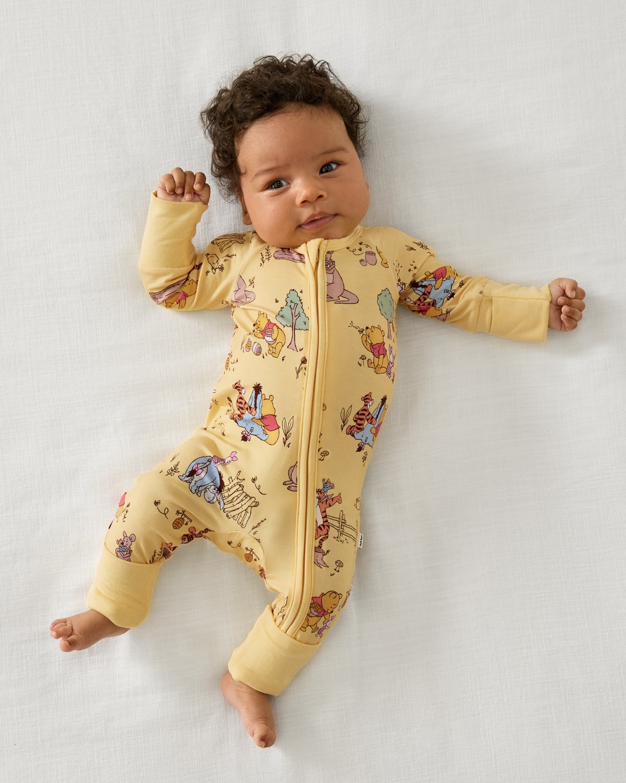 Aerial view of baby wearing the Disney Playtime With Pooh Zippy