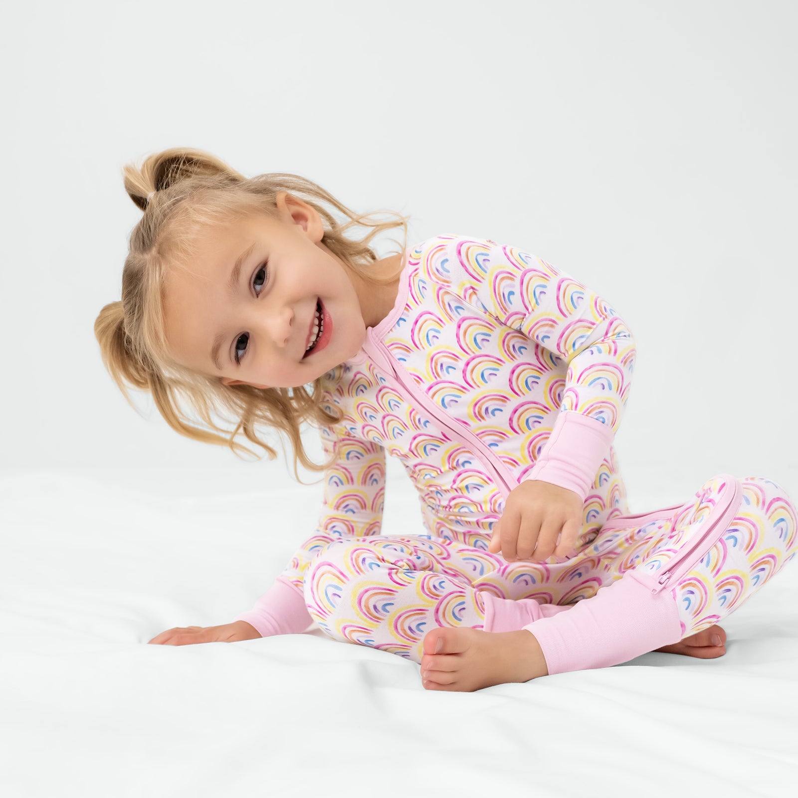 Sitting girl wearing the Pastel Rainbows Zippy