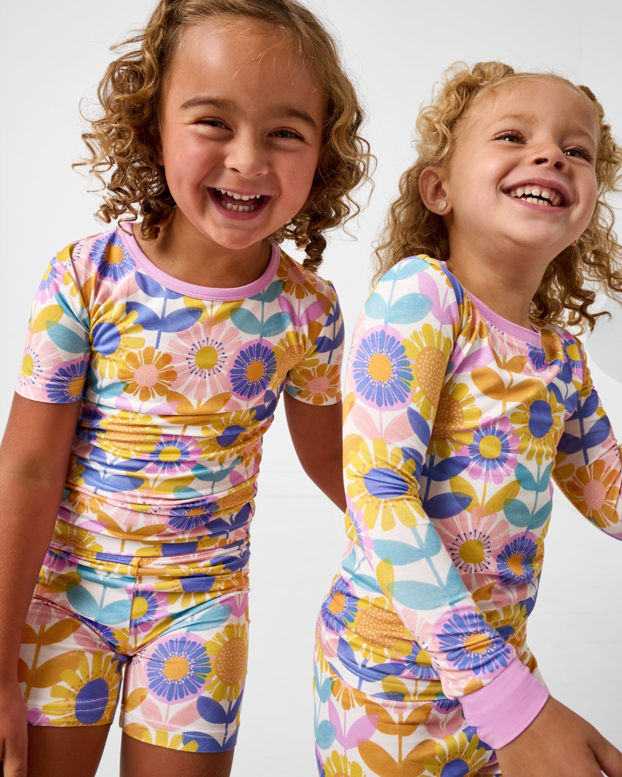 Two girls wearing the Petal Power Two-Piece Bamboo Pajama Set