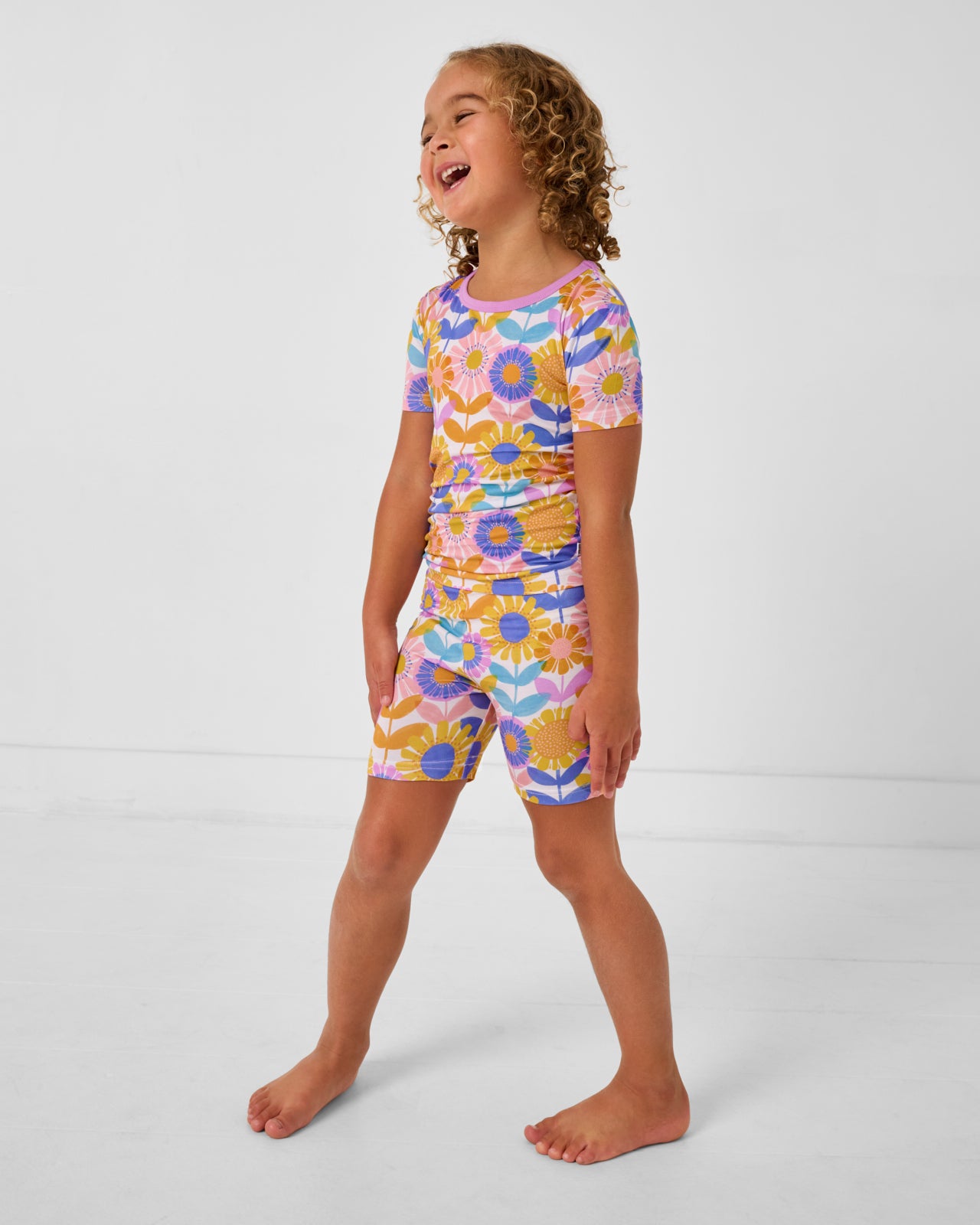 Child wearing the Petal Power Two-Piece Short Sleeve & Shorts Pajama Set