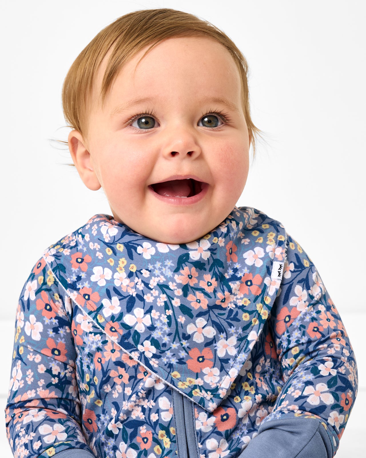 Baby wearing the Petite Petals Bandana Bib