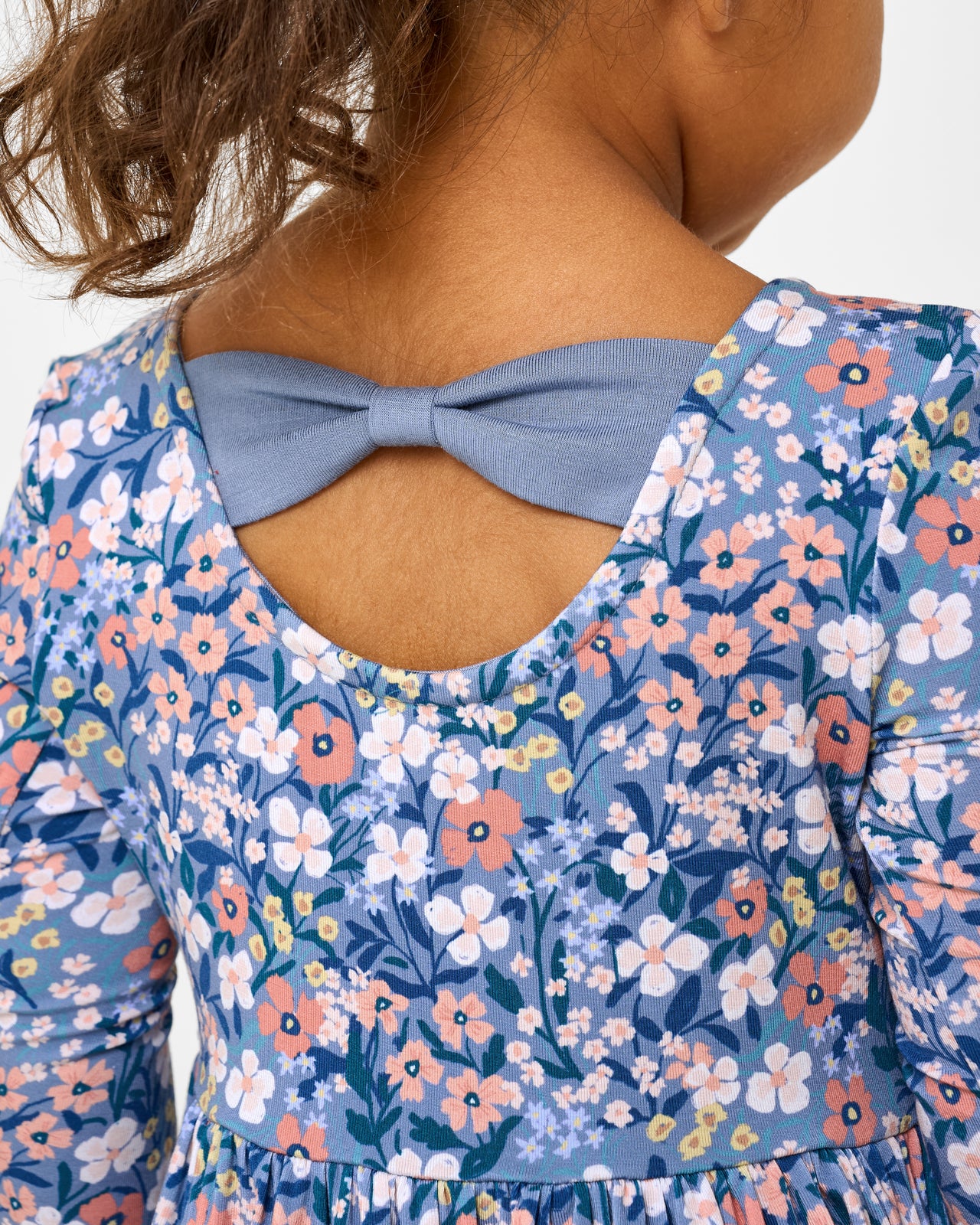 Close up of the bow detail on the Petite Petals Bow Back Skater Dress with Bodysuit