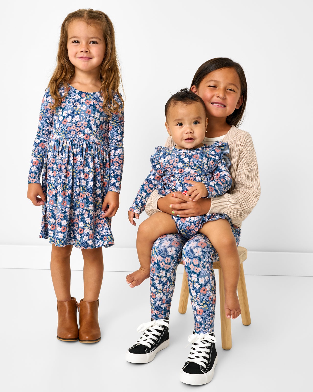 Three children wearing matching Petite Petals floral play styles