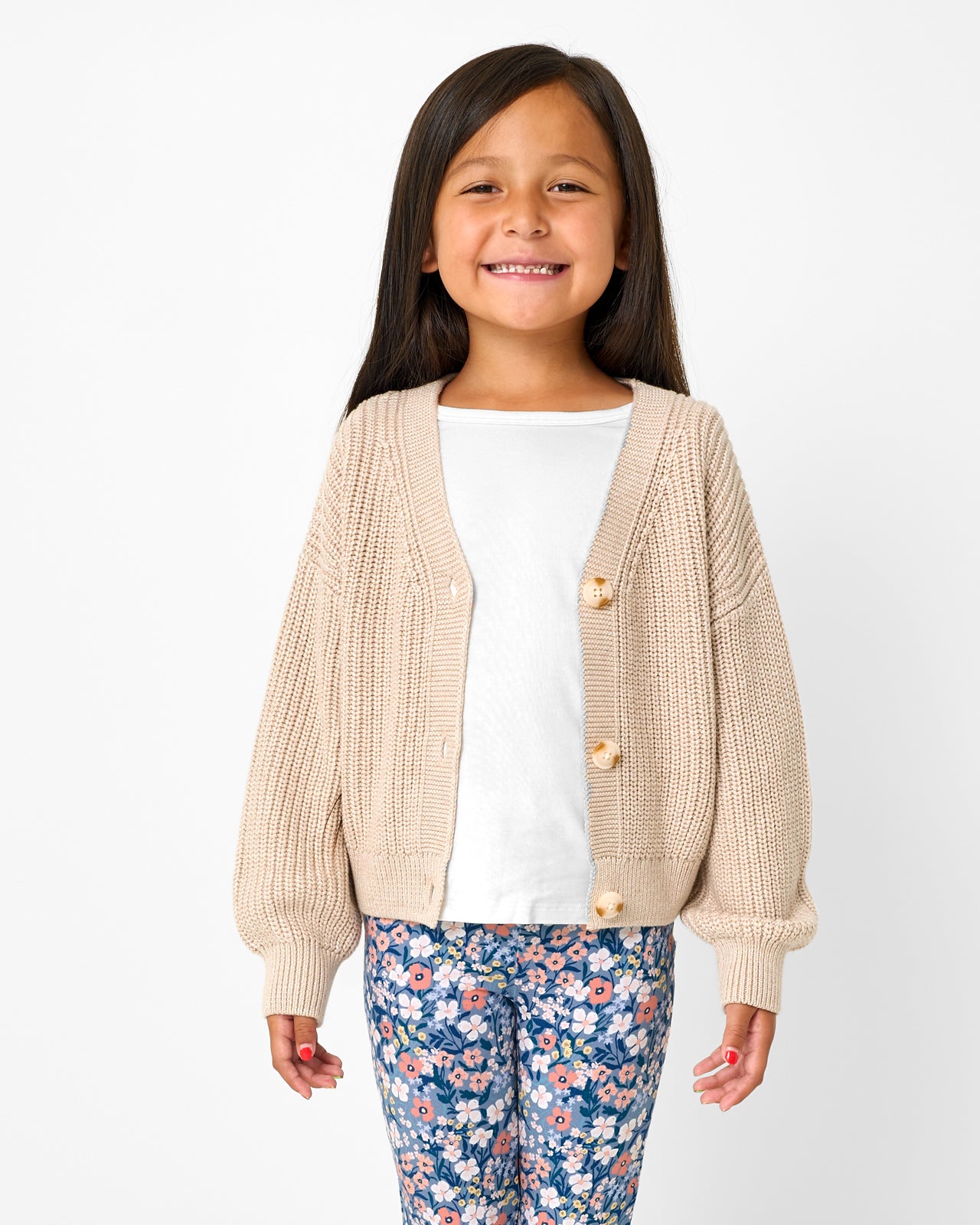 Girl wearing the Natural Heather Cropped Sweater layered over a white tee