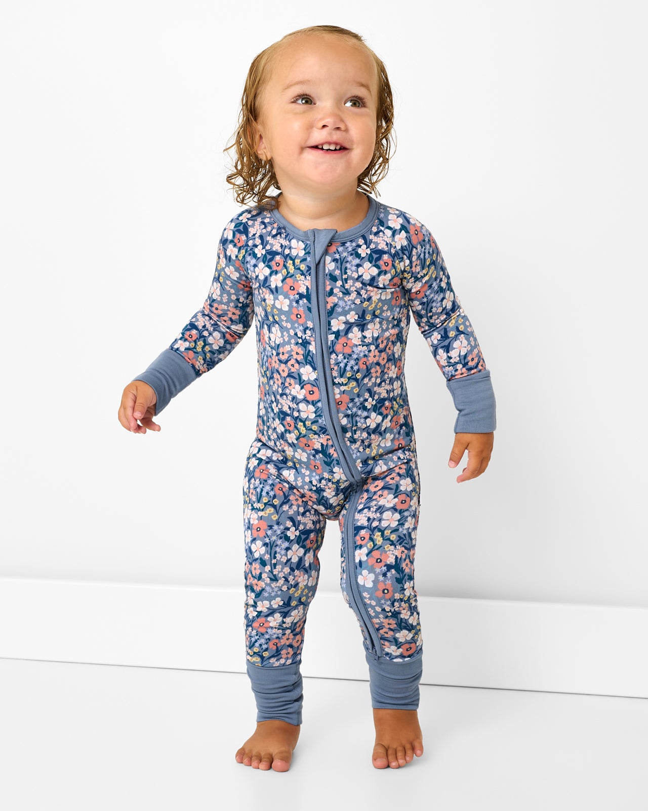 Walking toddler wearing the Petite Petals Zippy
