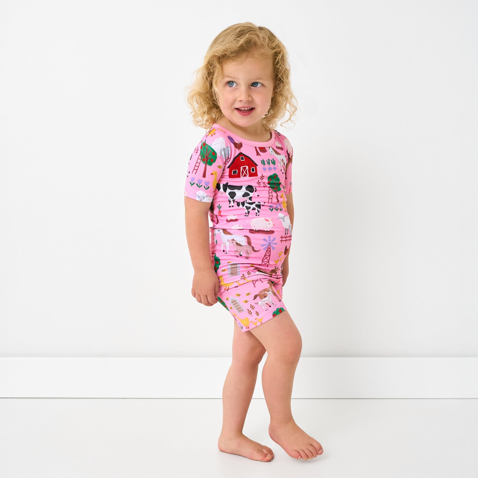 Alternate standing child wearing the Pink Farm Fam Two-Piece Short Sleeve & Shorts Pajama Set