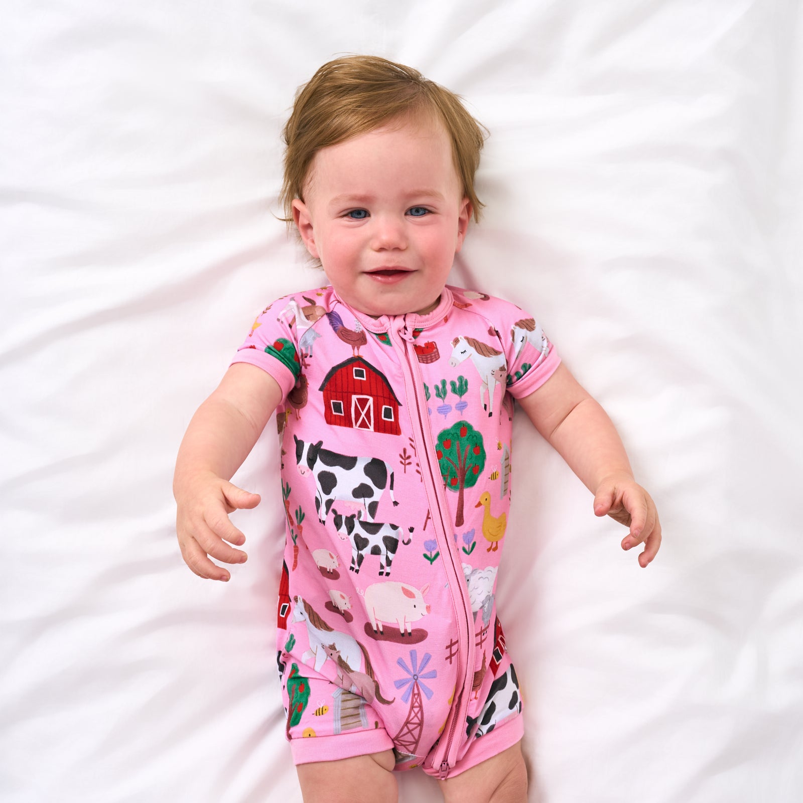 Alternate aerial view of child wearing the Pink Farm Fam Shorty Zippy