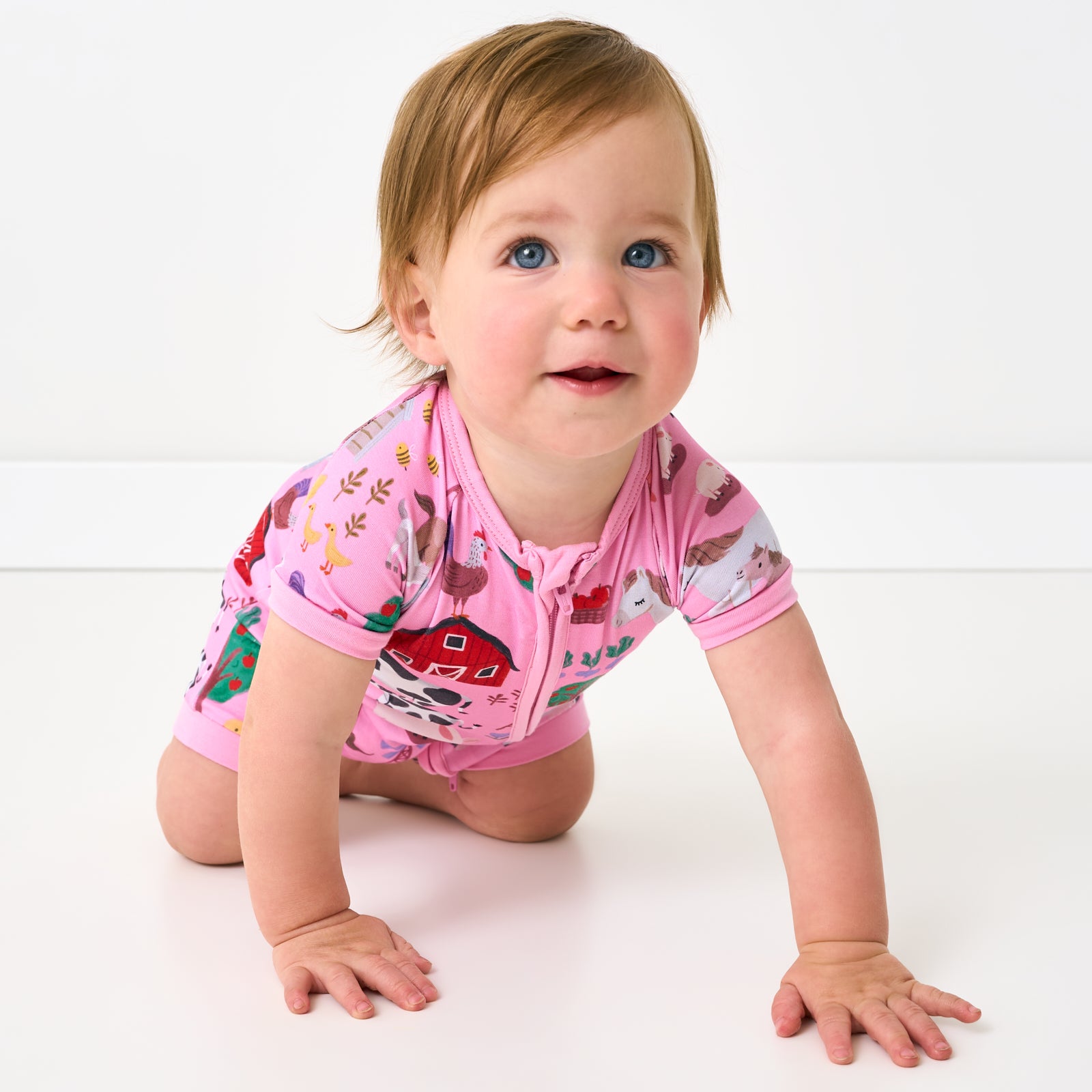 Crawling baby wearing the Pink Farm Fam Shorty Zippy