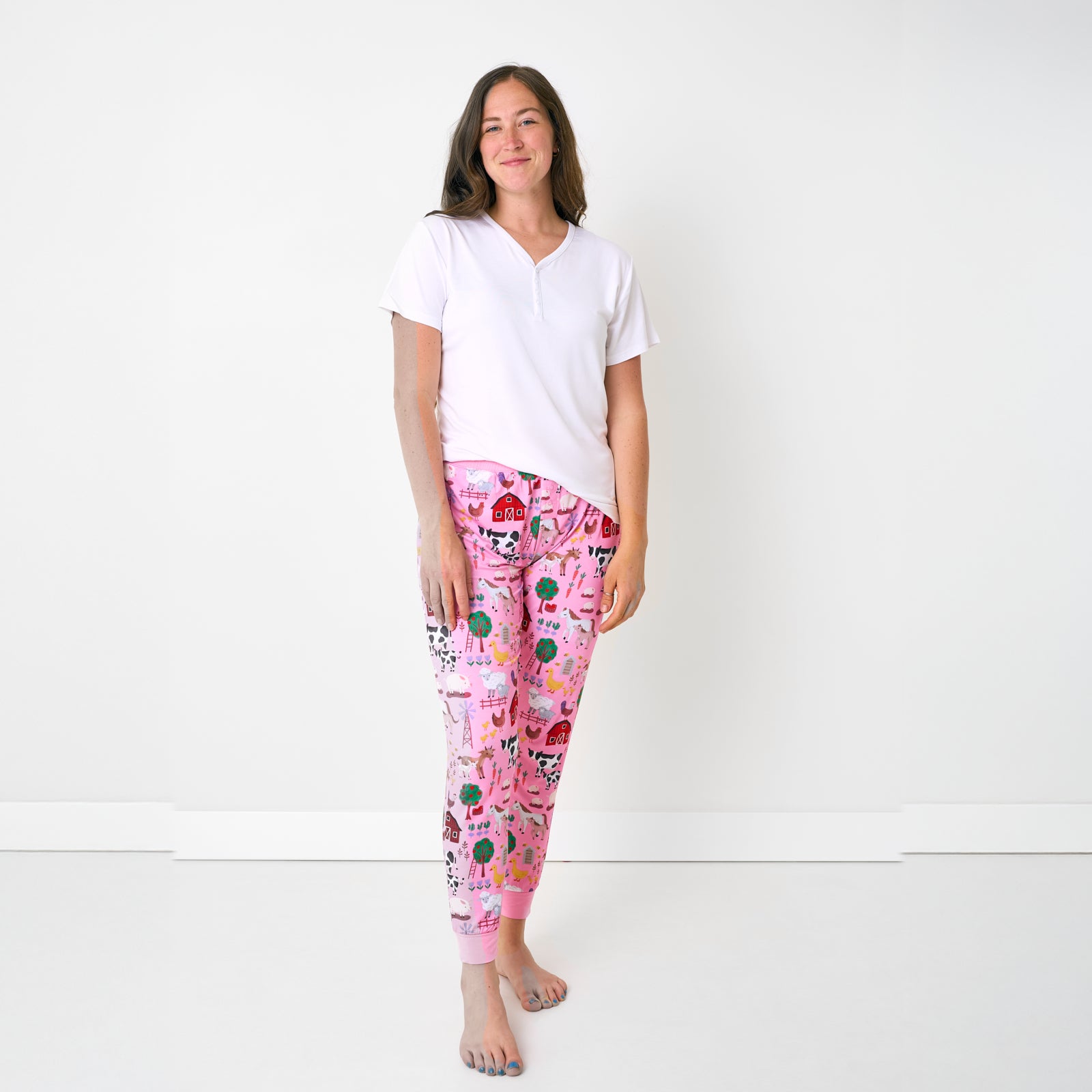Standing woman wearing the Pink Farm Fam Women's Pajama Pants with a white ss pj top