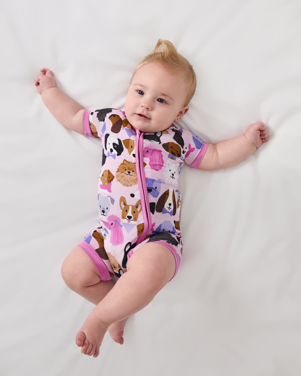 Aerial view of baby wearing the Pink Puppy Parade Shorty Zippy