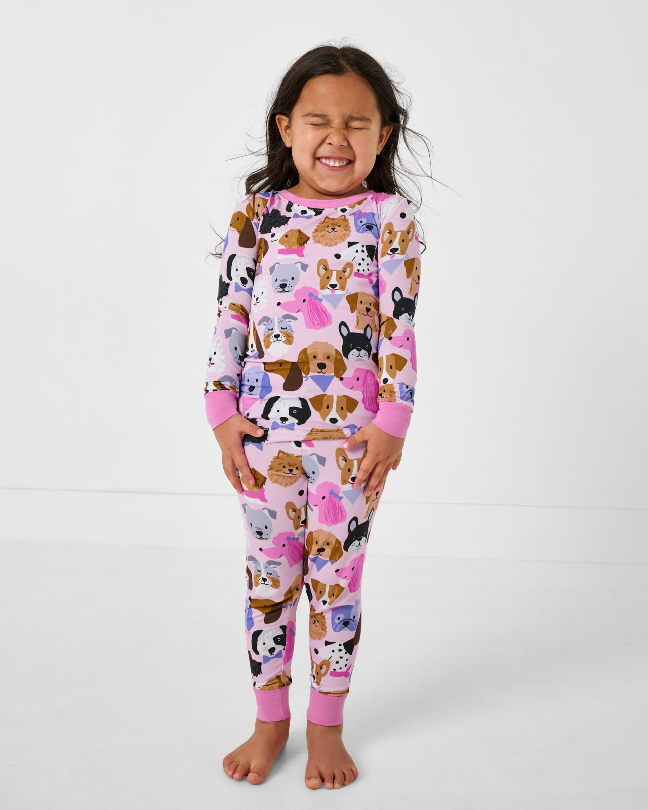 Standing girl wearing the Pink Puppy Parade Two-Piece Pajama Set