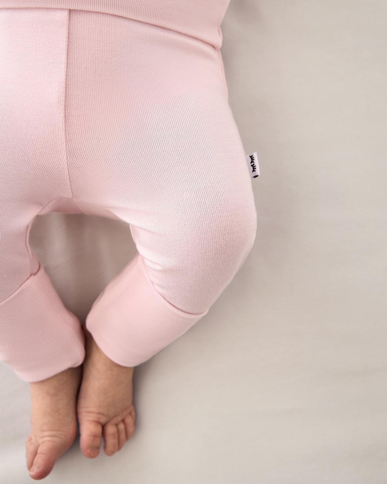 Close up of baby wearing the Prima Pink Fold Over Legging