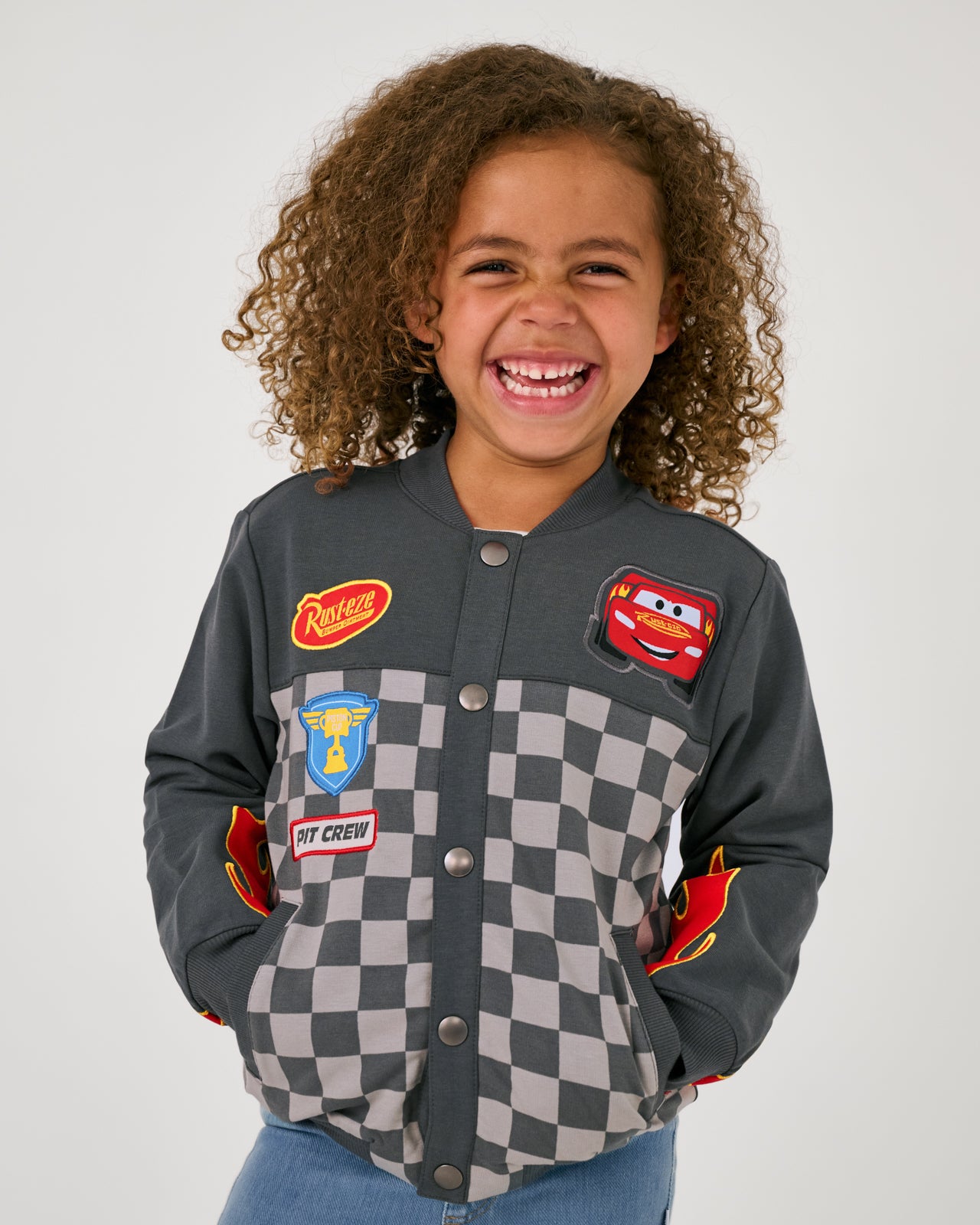 Girl wearing the Disney & Pixar Piston Cup Bomber Jacket buttoned up