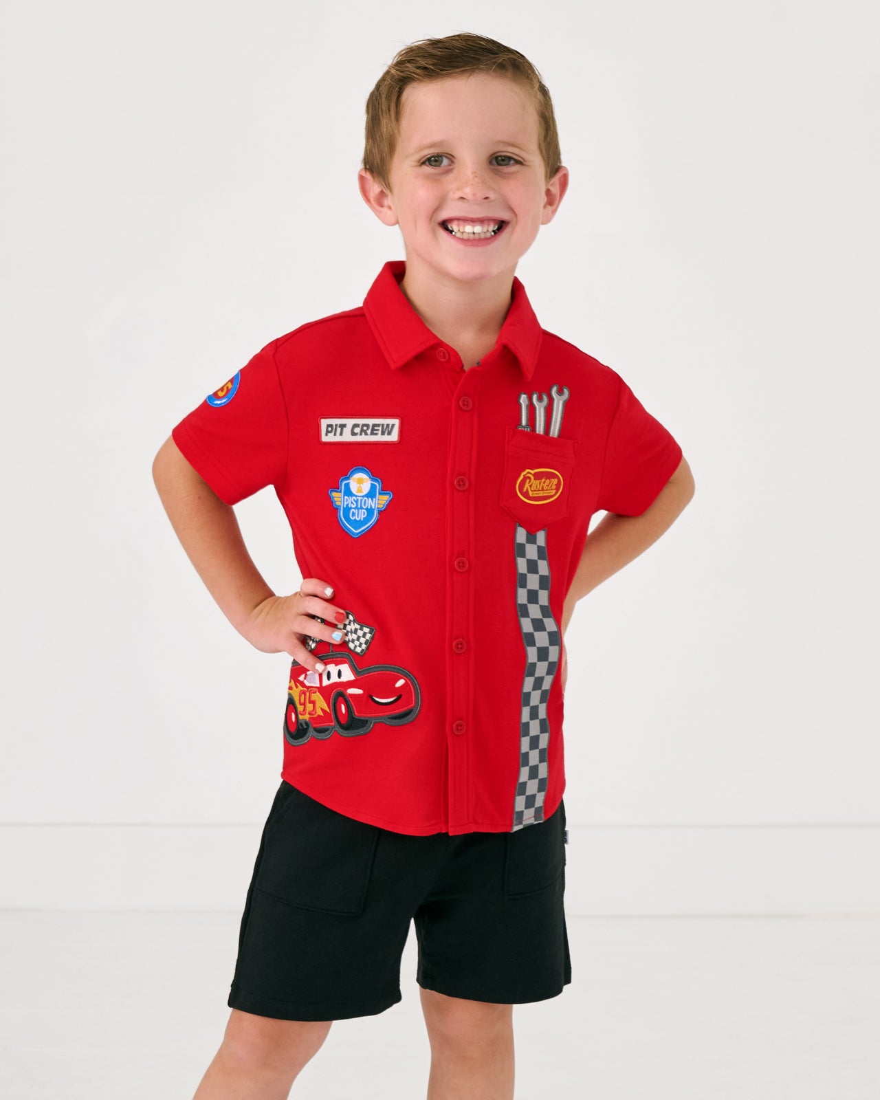 Boy wearing the Disney & Pixar Piston Cup Button Down Polo