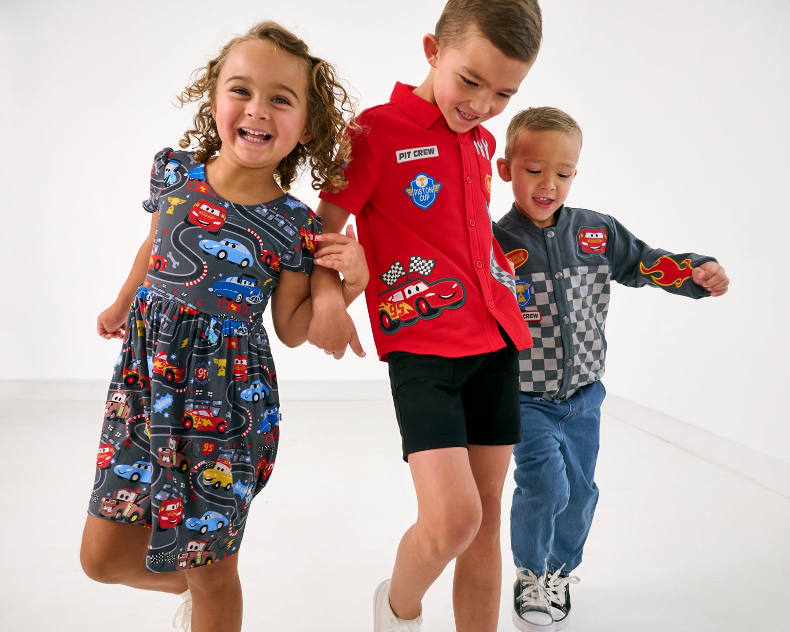 Three children wearing styles from the Disney Cars collection