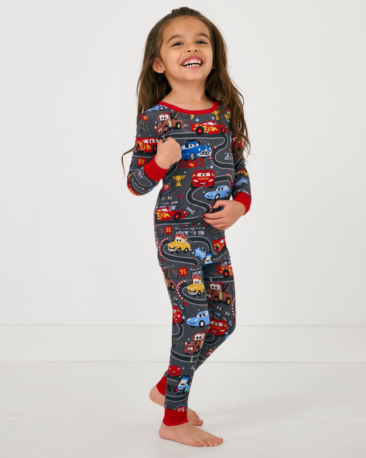 Girl wearing the Disney & Pixar Piston Cup Two-Piece Bamboo Pajama Set
