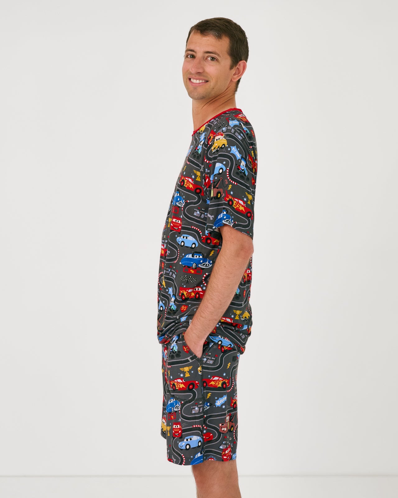 Side view of man wearing Disney & Pixar Piston Cup pajamas