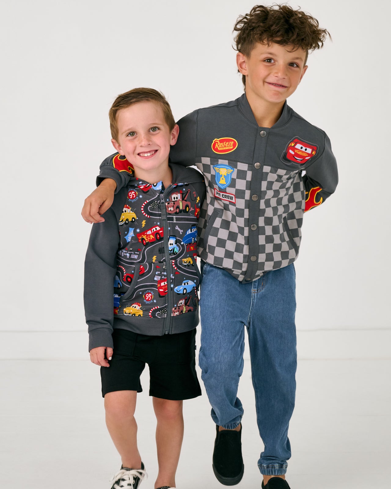 Two boys wearing matching styles from the Disney Cars collection